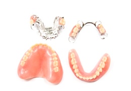 full and partial dentures against white background