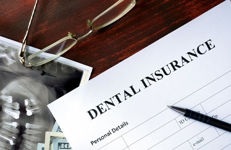 A dental insurance form next to an X-ray of teeth