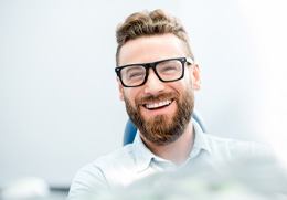 man smiling after getting Reveal clear aligners 