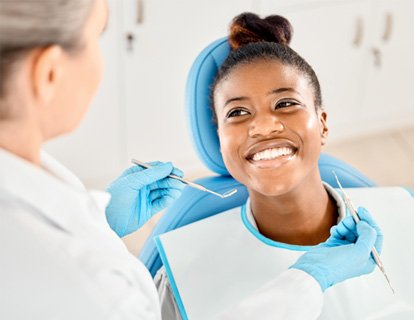 Woman smiling at dentist before having teeth examined