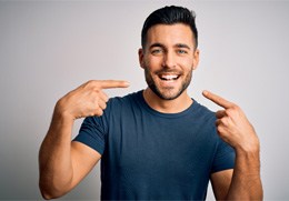 man showing off dental crowns in Goodlettsville