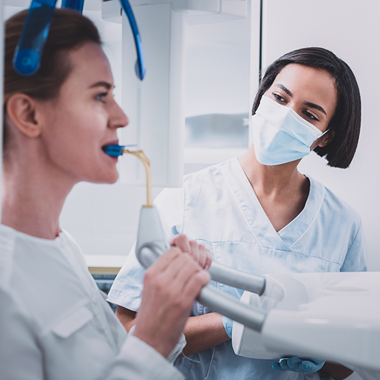 Woman getting a cone beam scan taken of her mouth
