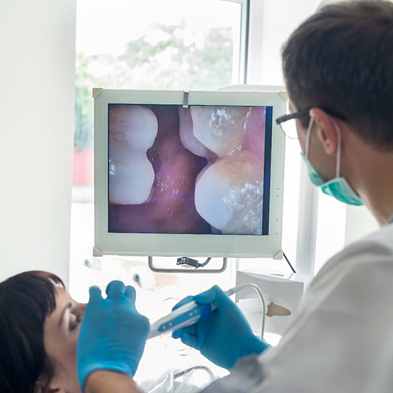 Dentist capturing close up photos of a patient's teeth