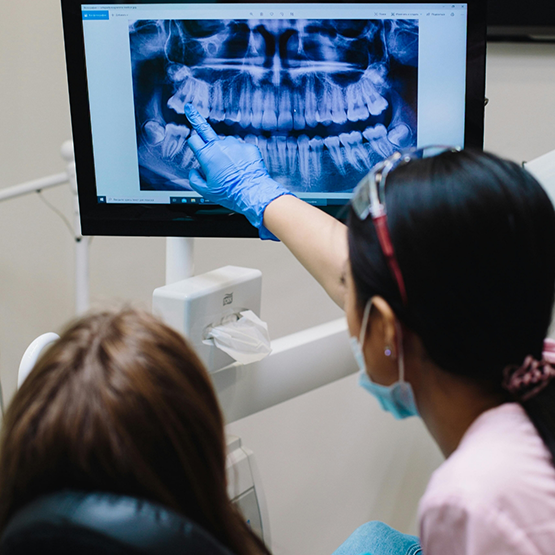 Dentist showing a patient an x ray of their teeth