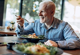 Man eating a chicken salad