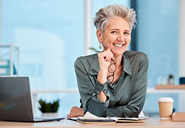 Woman sitting at desk smiling