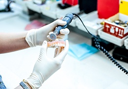 A lab worker making dentures