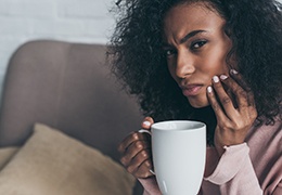 woman with coffee and tooth pain in Goodlettsville