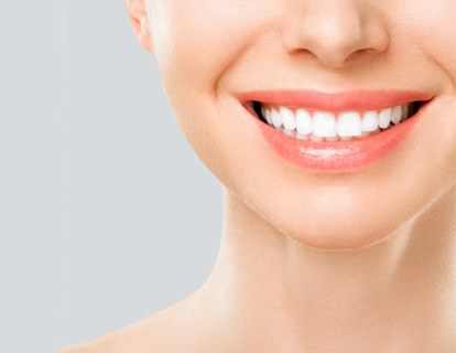 Nose-to-neck view of woman smiling