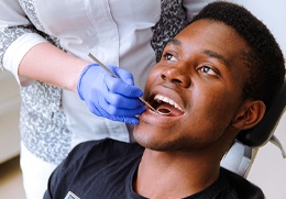 A young man having his teeth checked
