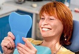 patient admiring her smile in a mirror