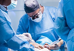 A team of dentists finishing a dental implant surgery