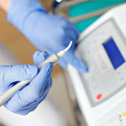 Dentist preparing to use soft tissue laser