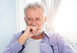 Older man in need to too replacement covering his smile