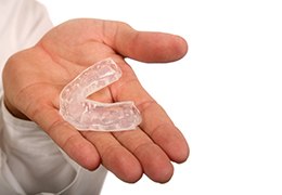person holding mouthguard
