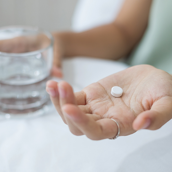 Person taking a white pill