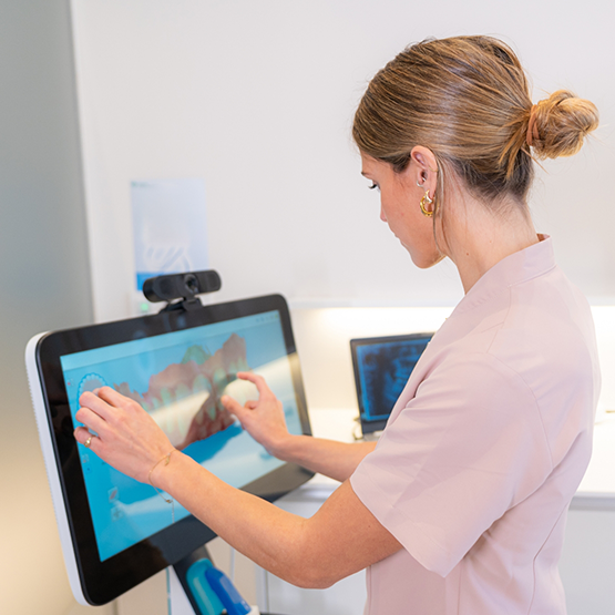 Miembro del equipo dental mirando un escaneo digital de los dientes de un paciente