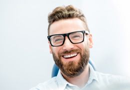 patient smiling while sitting in treatment chair   