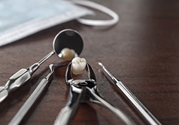 Dentist tools and wisdom tooth laying on table 