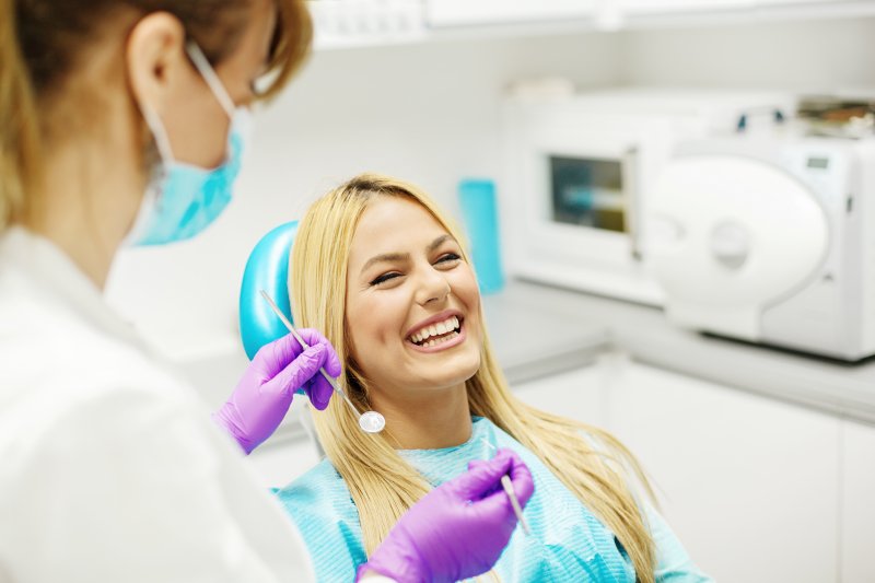 young woman smiling at dentist