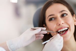 Woman with brown hair having a consultation with a cosmetic dentist