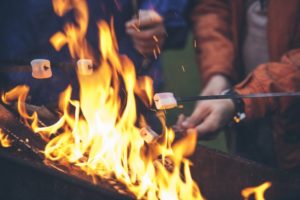 family roasting marshmallows over firepit from dentist in Goodlettsville