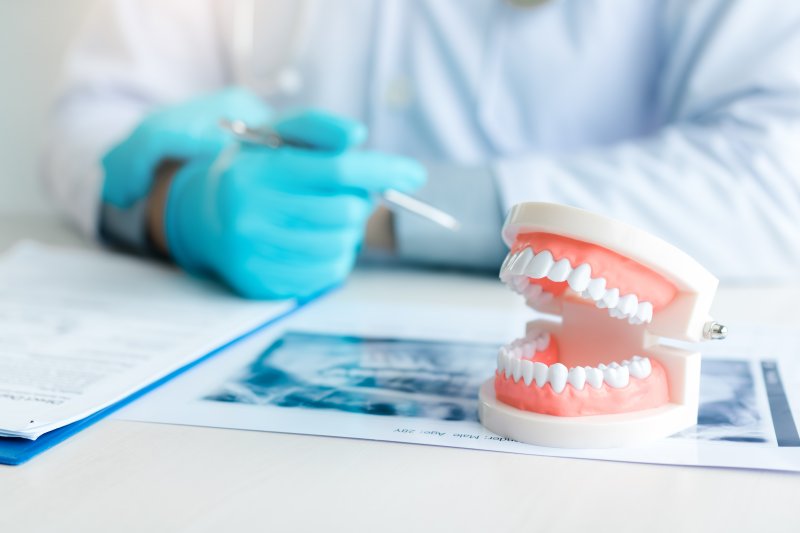 Close-up of dentures on desk near dentist