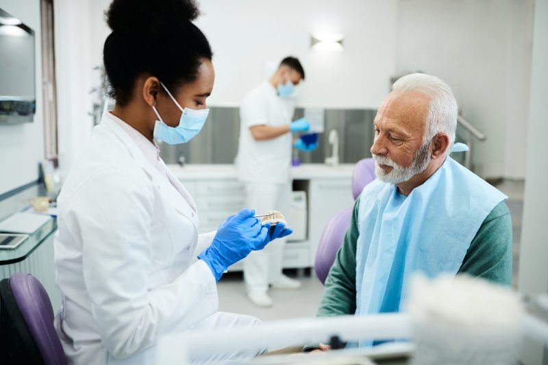 A dentist about to whiten dentures for a patient