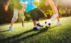 a group of kids playing soccer